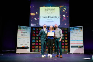 Laura Kearsley receives her certificate on stage from Patrick Monahan
