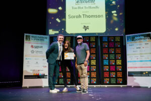 Sarah Thomson is presented with her winners certificate by Patrick Monahan