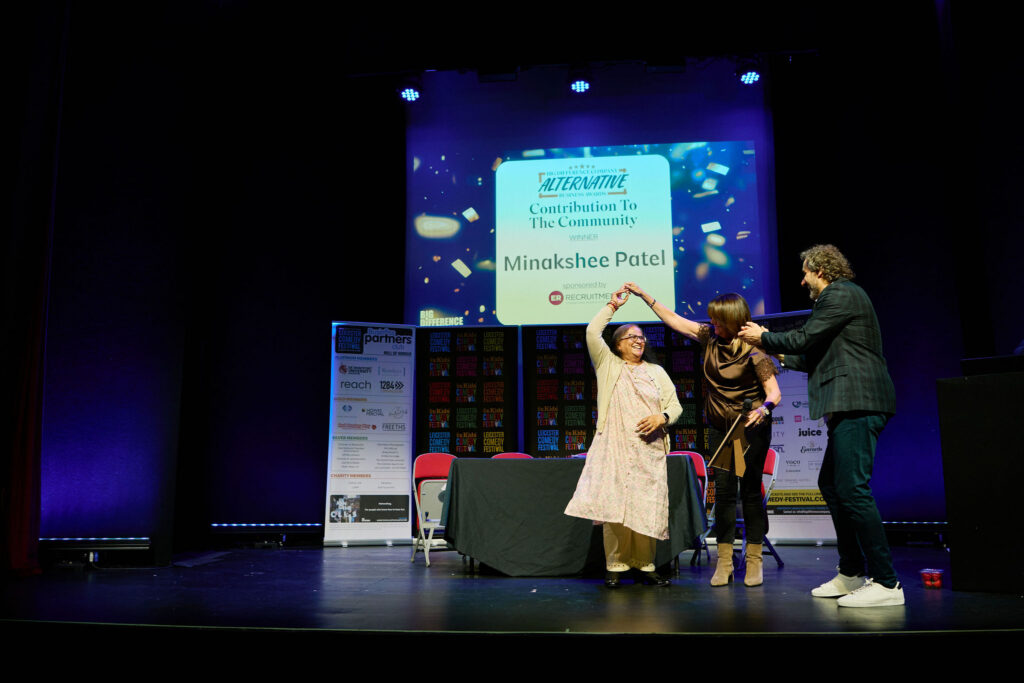 Minakshee Patel, Eileen Perry & Patrick Monahan dancing on stage